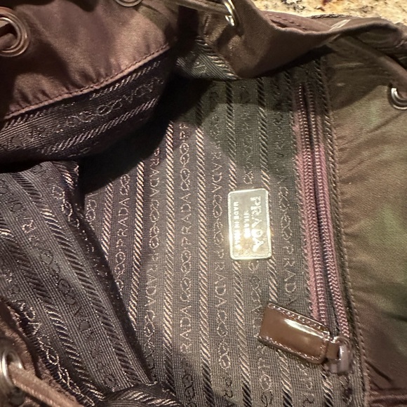 Prada backpack. Pre loved. Brown in color. Pockets inside and outside. - Picture 3 of 12
